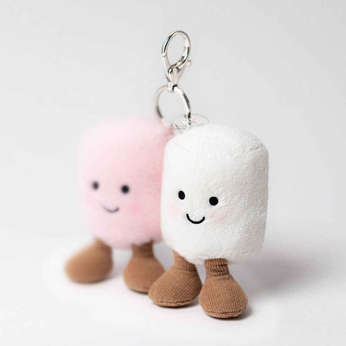 Two plush keychains shaped like marshmallows with smiling faces on a light gray background.