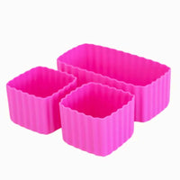 
              A set of three pink silicone bento cups of different sizes, with one rectangular and two square cups.
            